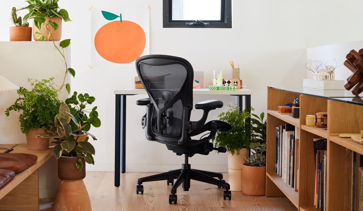 Herman Miller Aeron Remastered chair in a workspace, showing the Pellicle suspension seat