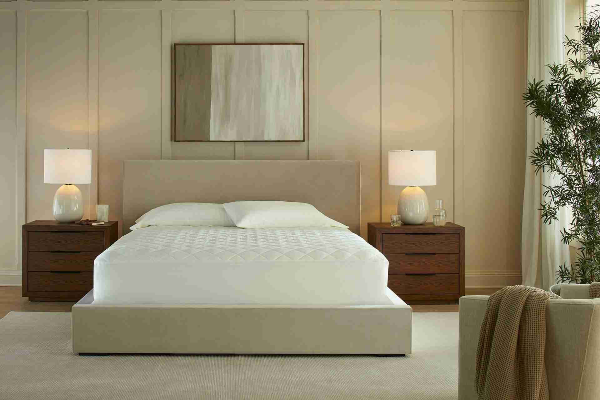 Organic mattress topper on a bed in a bright bedroom